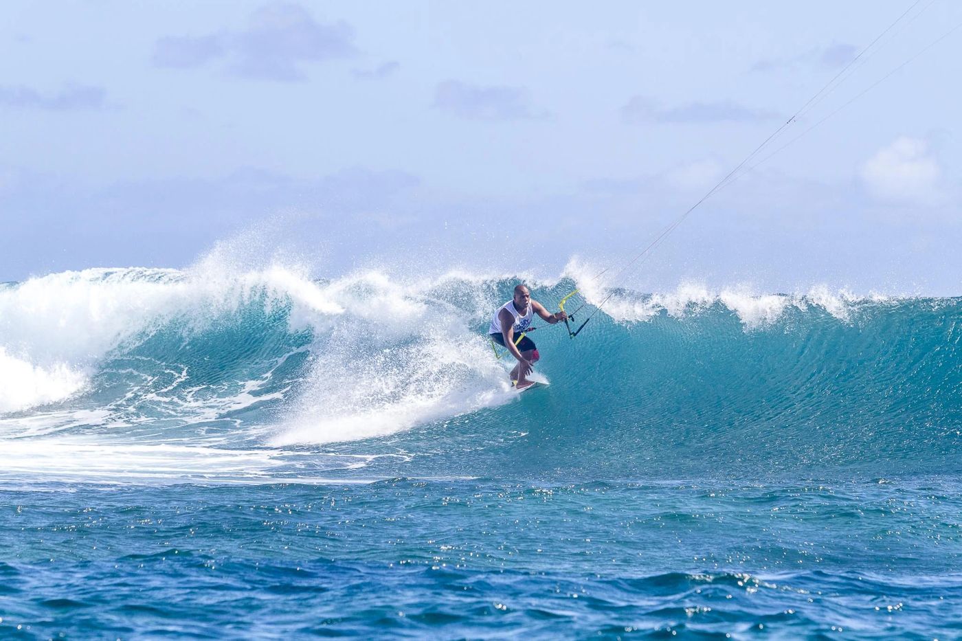 Kitesurfer riding a wave off the reef